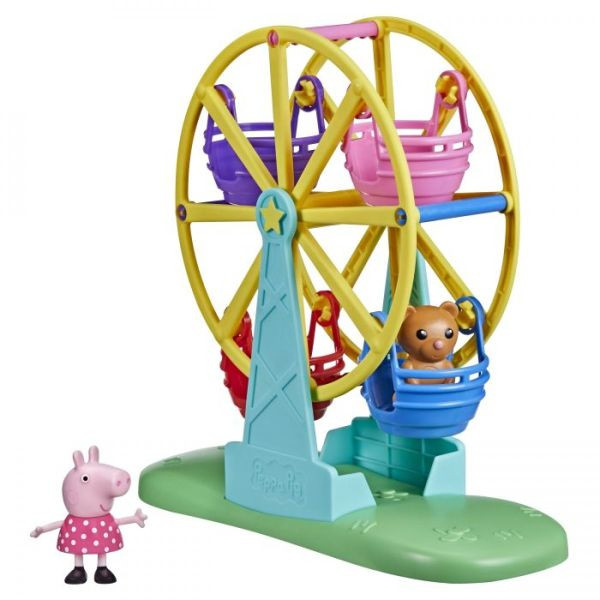 Peppa Pig steht neben einem Riesenrad